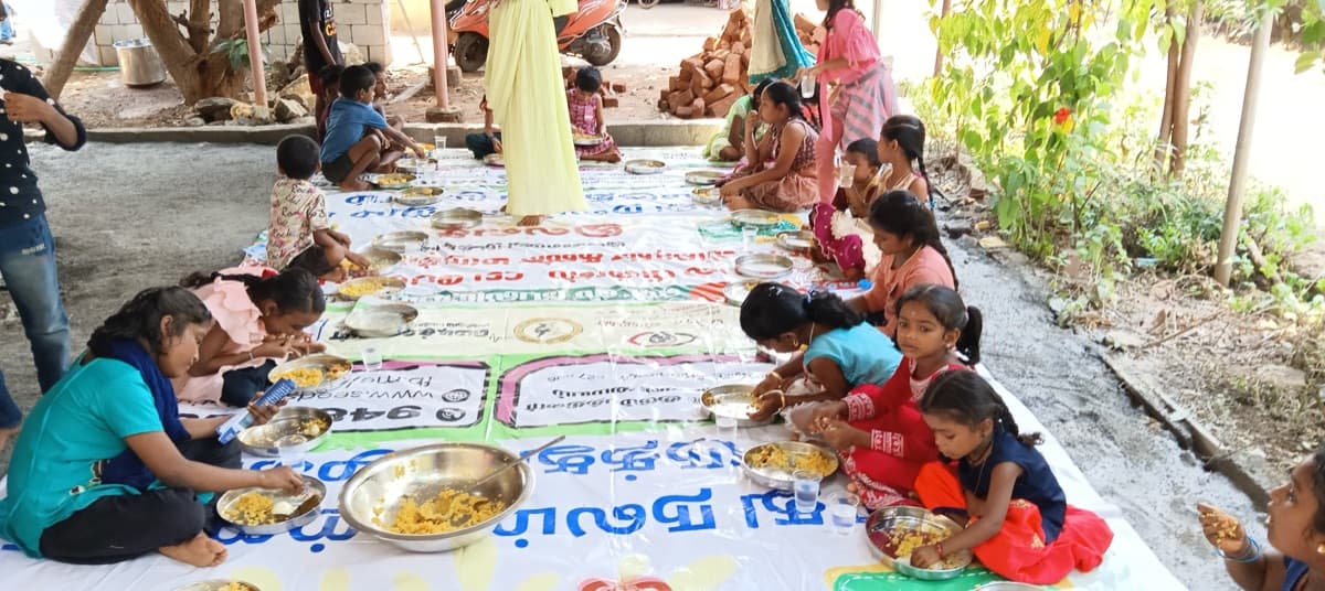 Children eating together outdoors in fellowship
