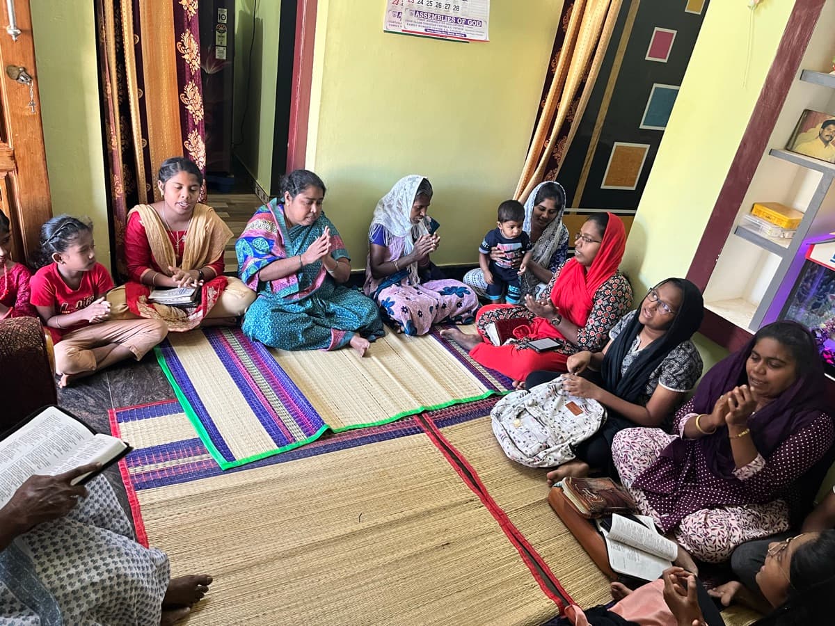 Women gathered in a circle for prayer and Bible study